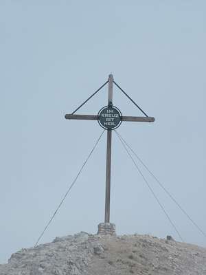 Wir haben es bis zum Gipfelkreuz geschafft, wenn wir es vor Wolken auch kaum sehen.