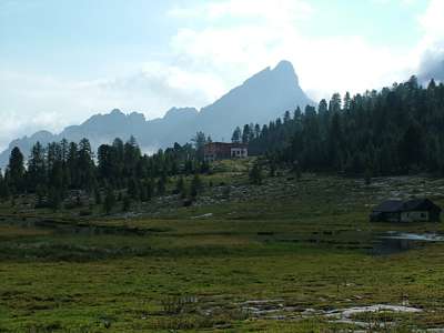 Die &Uuml;cia de Fanes in der Morgensonne. Die Bergsilhouette hinter der H&uuml;tte ist der Ciamin [2610m], an den sich nach links die verschiedenen Bergspitzen bis zum Banch dal Se anschlie&szlig;en.